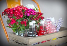 wooden crate with flowers and drinks